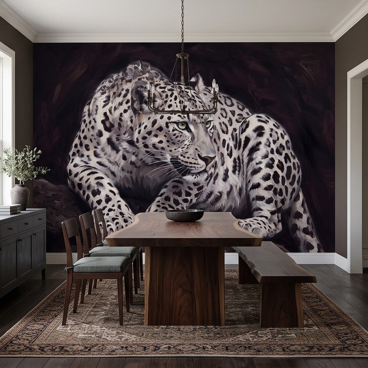 Snow leopard wall mural with front-view reclining pose, spotted coat and calm expression
