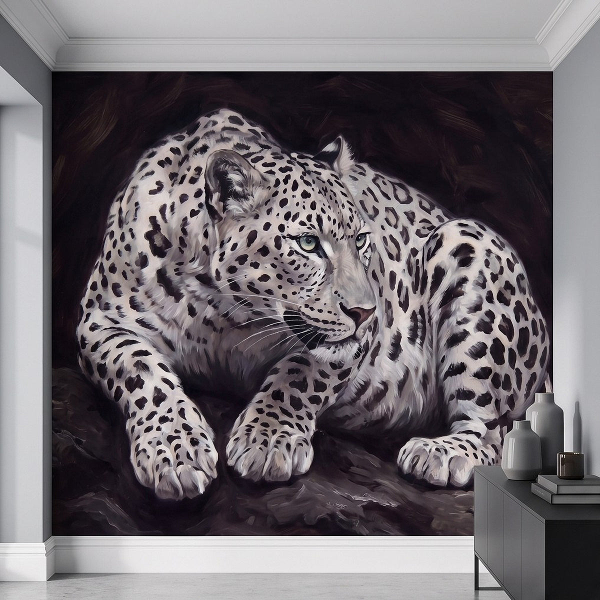 Snow leopard wall mural in a white room with a crouching cat and spotted pattern