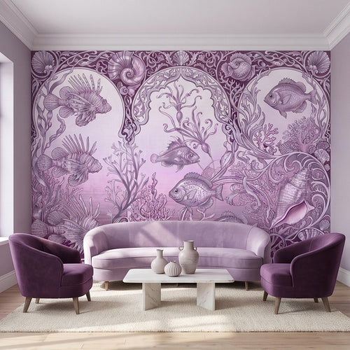 Purple ocean life wall mural with coral reef fish and seashell details behind a sofa and chairs